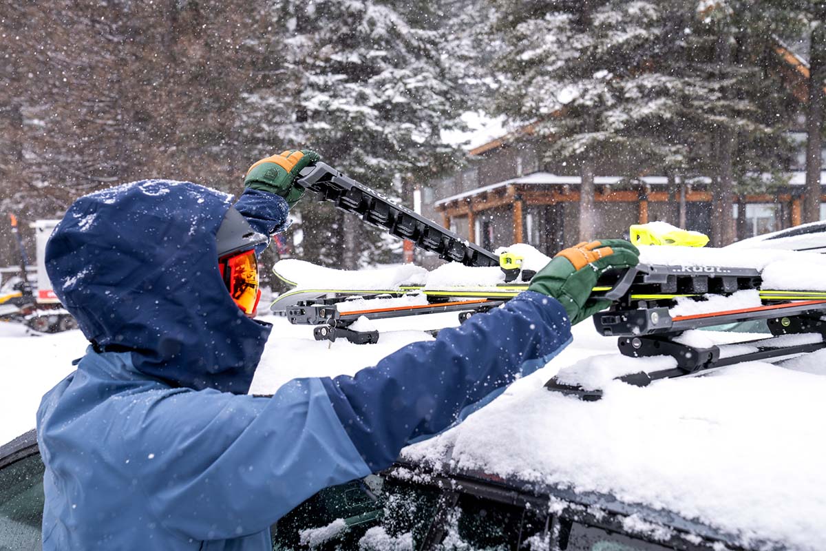 Adjusting rooftop ski rack with Hestra Fall Line gloves